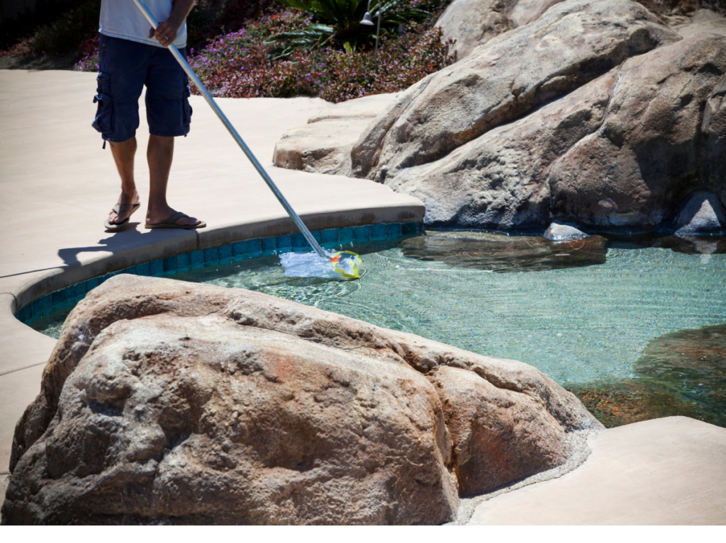 A man is cleaning his pool 